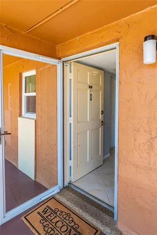 a view of a room that has a door and wooden floor