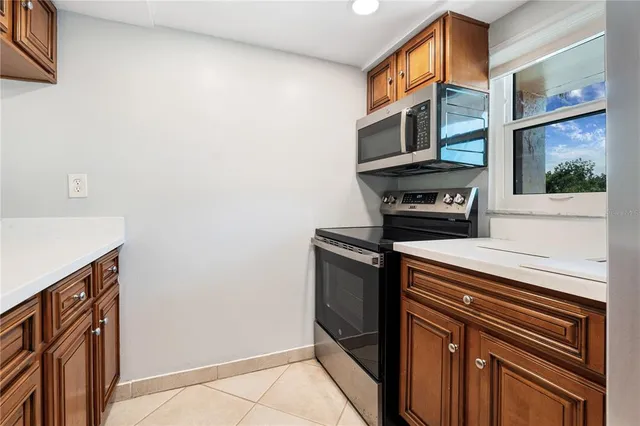 a kitchen with stainless steel appliances a stove microwave and a refrigerator