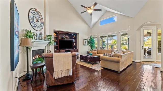 a living room with furniture a large window and a fireplace