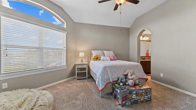 a bedroom with bed and a window