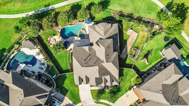 an aerial view of a house with a yard and plants