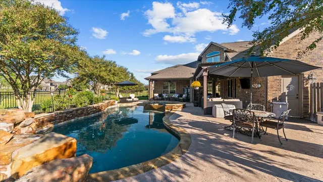 a view of a patio with chairs and umbrellas