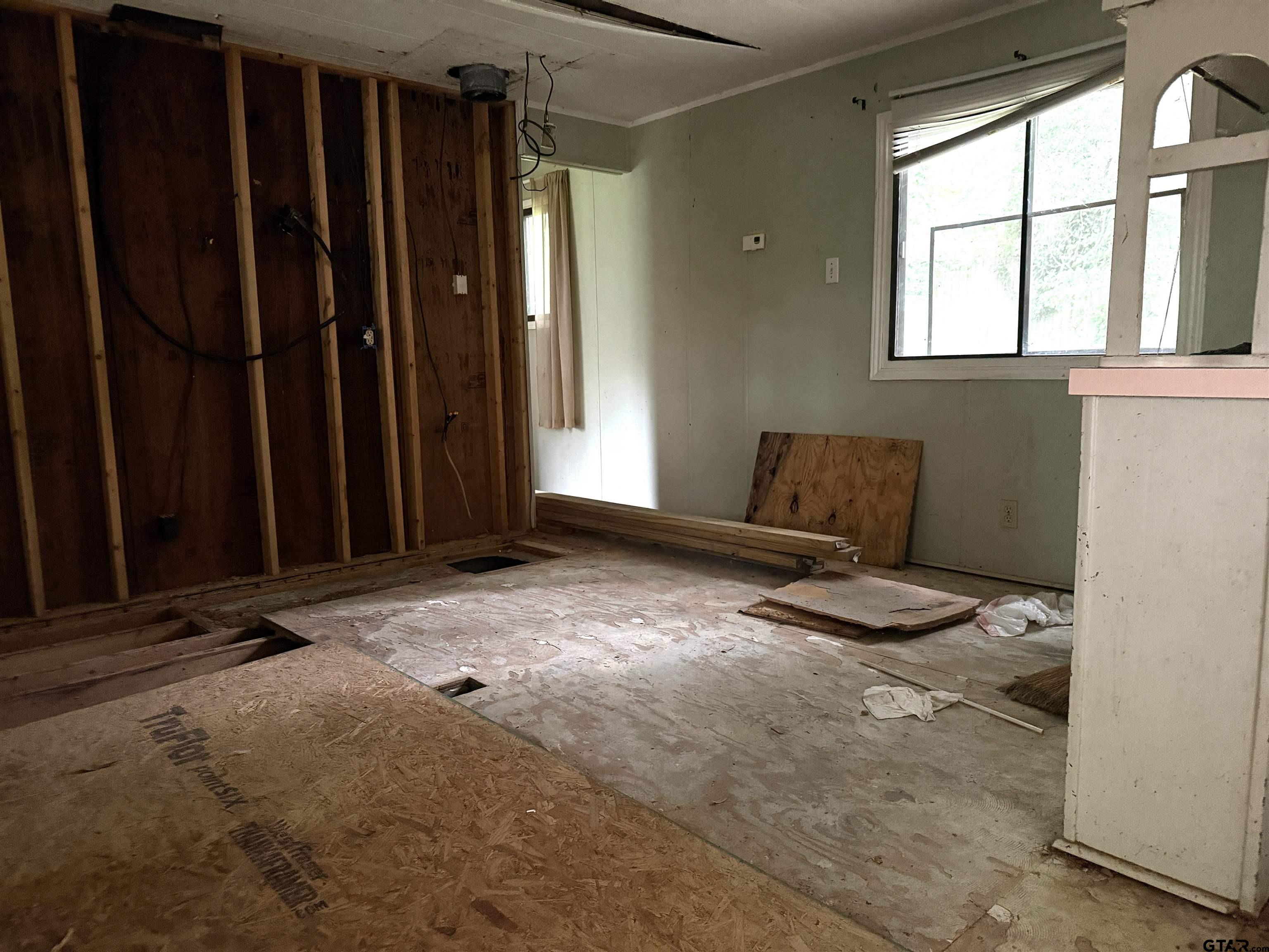 4604 Skyline Drive Chandler, TX 75758 - Photo 5 of 17 a view of an empty room with a window and bathroom