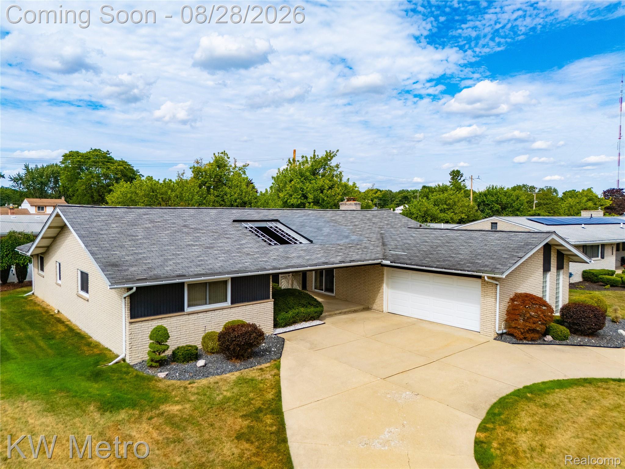17700 Adrian Road Southfield, MI 48075 - Photo 19 of 24 Brick exterior with a gray shingle roof, integrated garage, and a concrete driveway