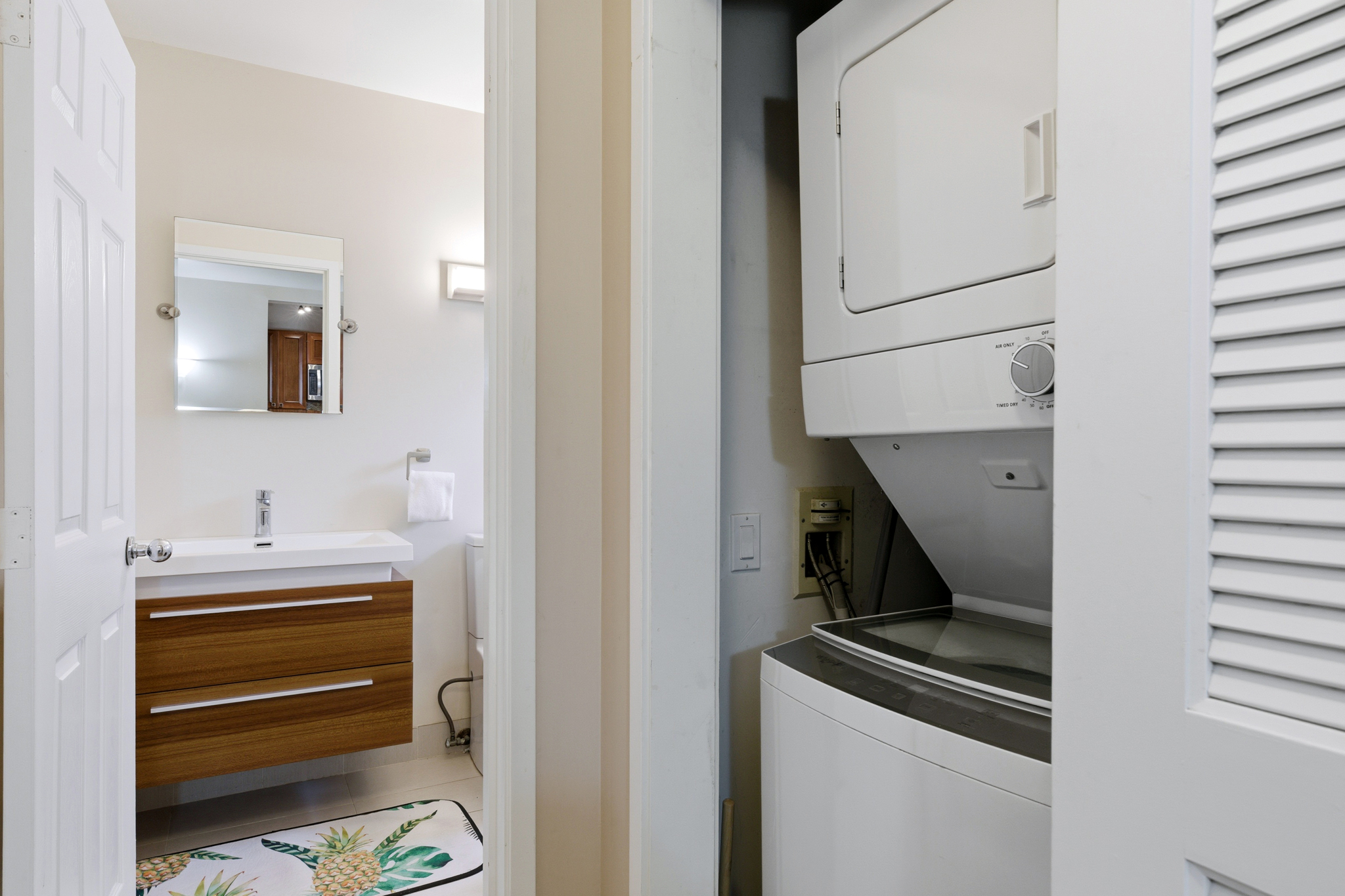 68-1010 Keana Place, Unit E206 Waikoloa, HI 96738 - Photo 17 of 30 a bathroom with a sink and a mirror