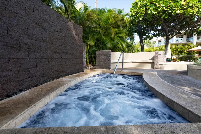 a view of a patio with chairs and potted plants