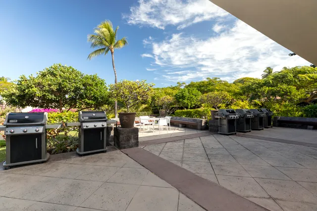 a view of a patio with table and chairs under an umbrella