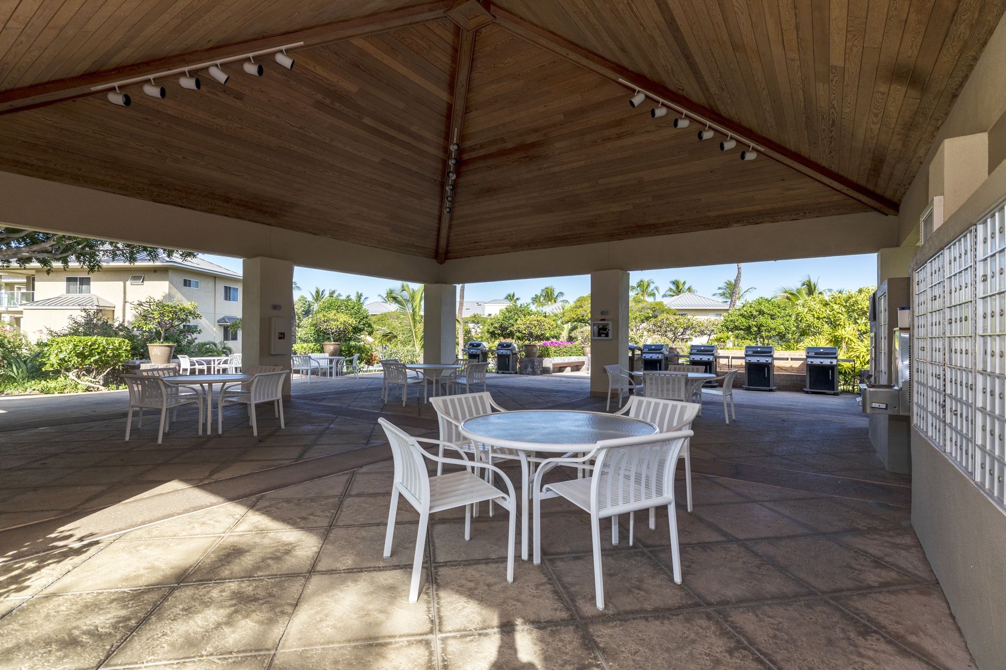 68-1010 Keana Place, Unit E206 Waikoloa, HI 96738 - Photo 28 of 30 a view of a patio with table and chairs under an umbrella