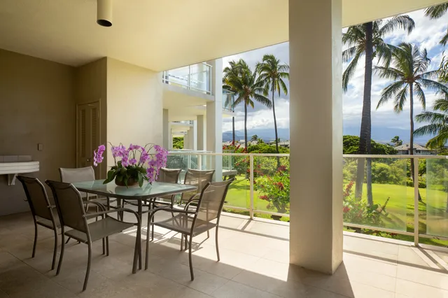 a view of a dining room with furniture and a potted plant