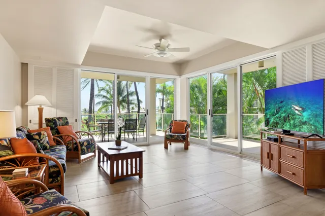 a living room with furniture and floor to ceiling windows