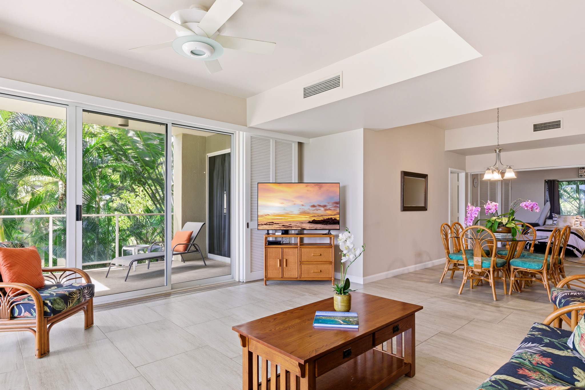 68-1010 Keana Place, Unit E206 Waikoloa, HI 96738 - Photo 9 of 30 a living room with furniture a flat screen tv and a large window