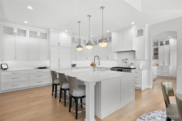 a large kitchen with a table and chairs