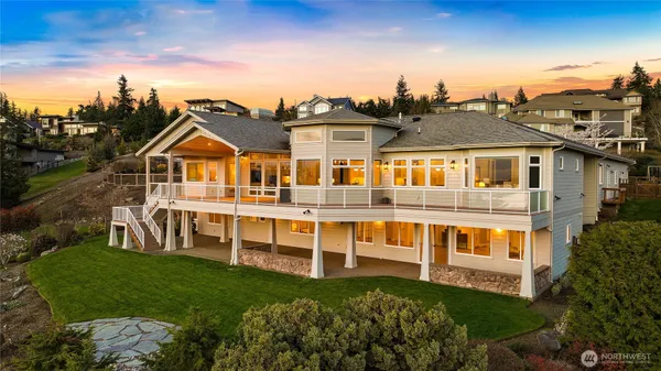a view of a house with a big yard and potted plants