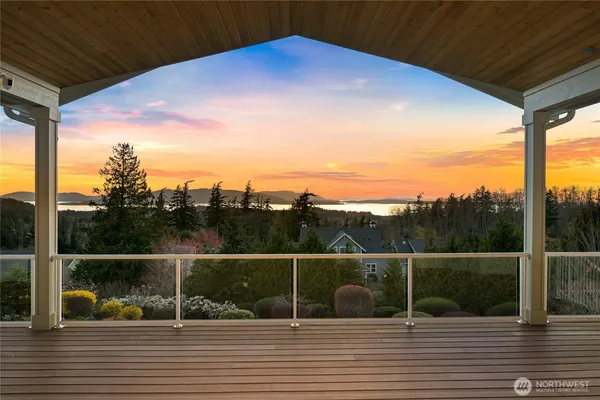 a view of balcony with mountain view and wooden floor