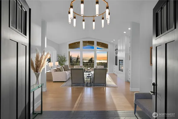 an entryway and dining room with wooden floor