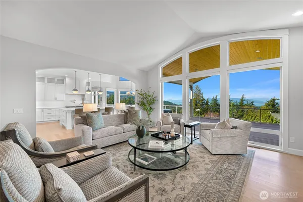 a living room with furniture and floor to ceiling windows