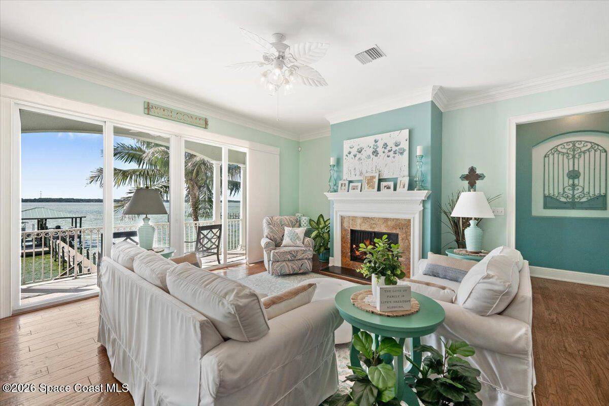 2555 South Tropical Trail Merritt Island, FL 32952 - Photo 11 of 91 a living room with furniture a fireplace and a large mirror