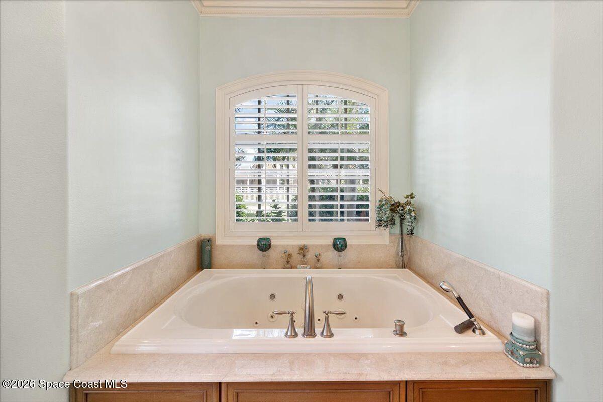 2555 South Tropical Trail Merritt Island, FL 32952 - Photo 15 of 91 a white bath tub sitting in a bathroom next to a window