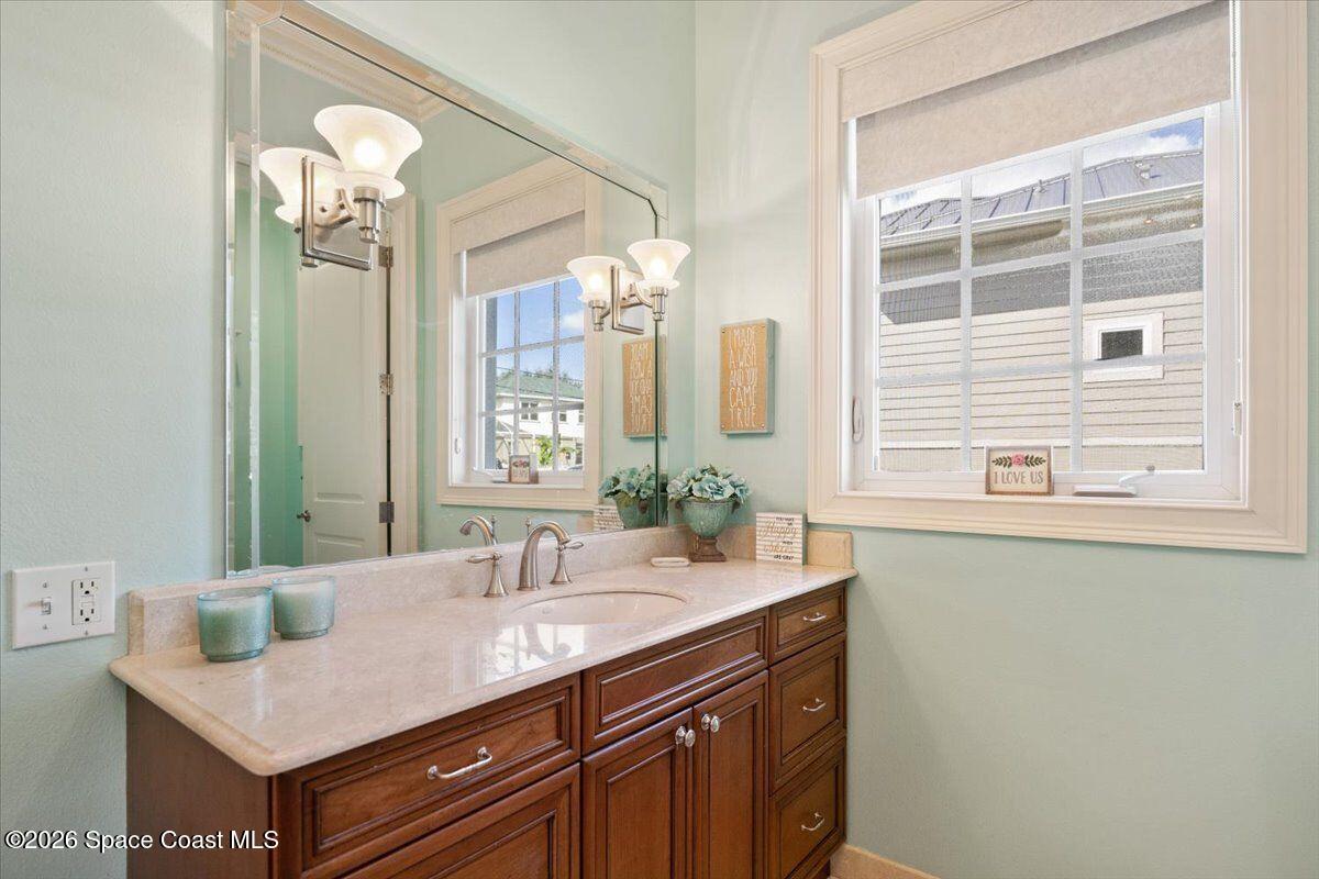 2555 South Tropical Trail Merritt Island, FL 32952 - Photo 16 of 91 a bathroom with a sink a vanity and a mirror