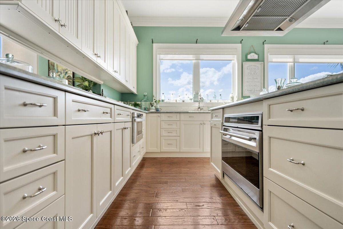 2555 South Tropical Trail Merritt Island, FL 32952 - Photo 30 of 91 a kitchen with stainless steel appliances cabinets and a window