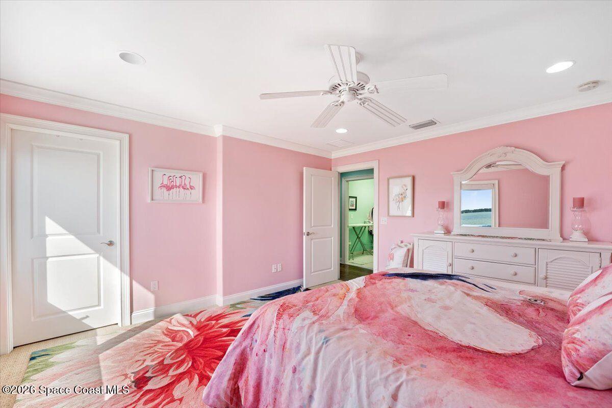 2555 South Tropical Trail Merritt Island, FL 32952 - Photo 40 of 91 a bedroom with a bed dresser and a window