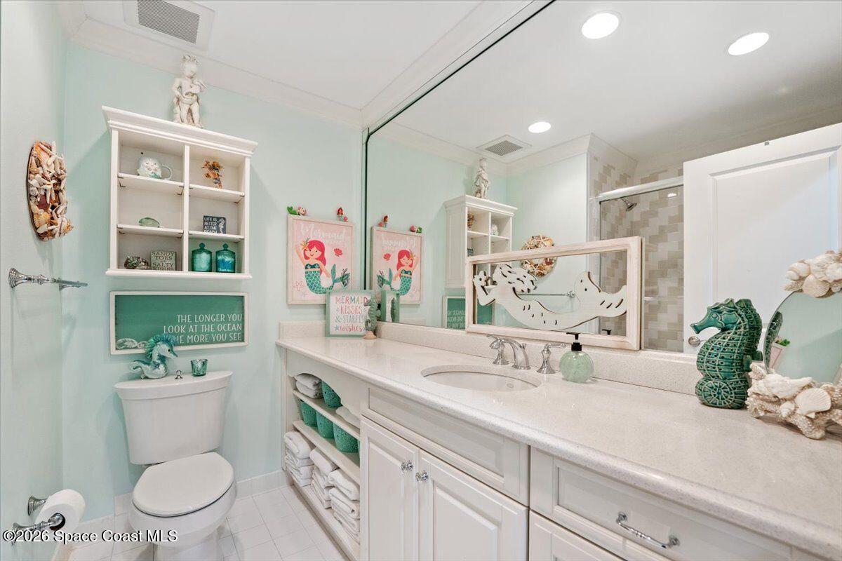 2555 South Tropical Trail Merritt Island, FL 32952 - Photo 41 of 91 a bathroom with a granite countertop sink mirror vanity and toilet
