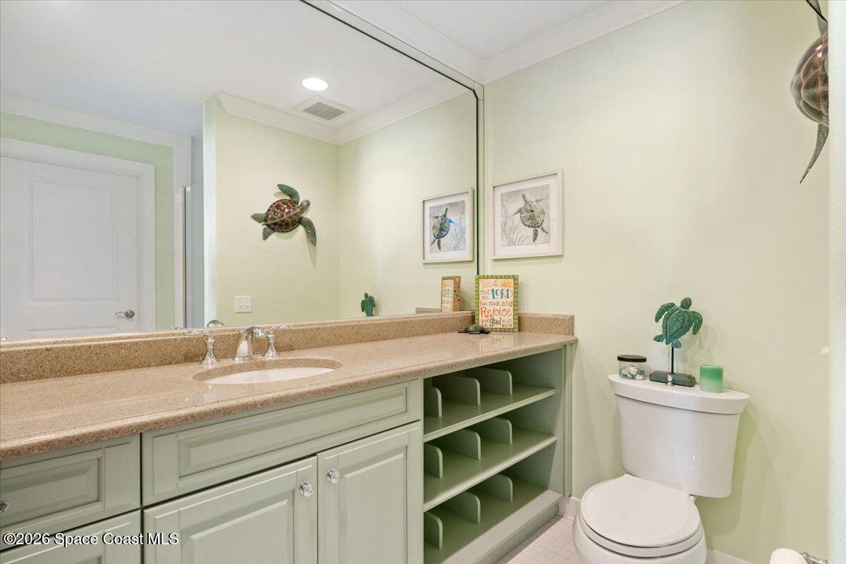 2555 South Tropical Trail Merritt Island, FL 32952 - Photo 44 of 91 a bathroom with a toilet a sink and mirror