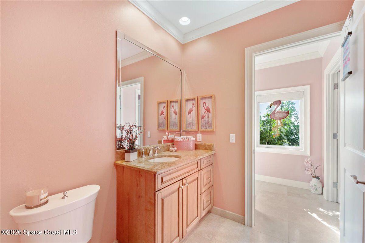 2555 South Tropical Trail Merritt Island, FL 32952 - Photo 48 of 91 a bathroom with a double vanity sink toilet and a mirror