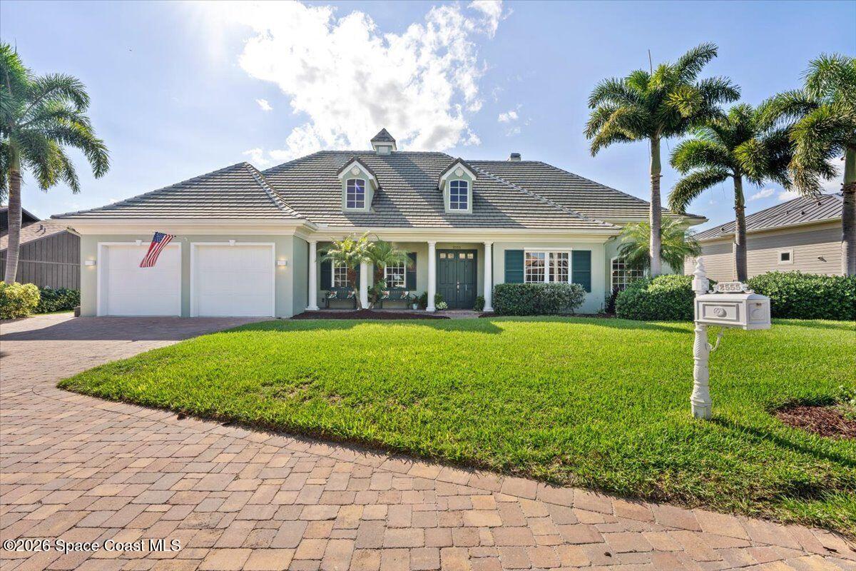2555 South Tropical Trail Merritt Island, FL 32952 - Photo 5 of 91 a front view of a house with a garden and plants