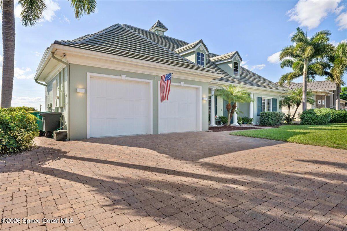 2555 South Tropical Trail Merritt Island, FL 32952 - Photo 6 of 91 a front view of a house with a garden