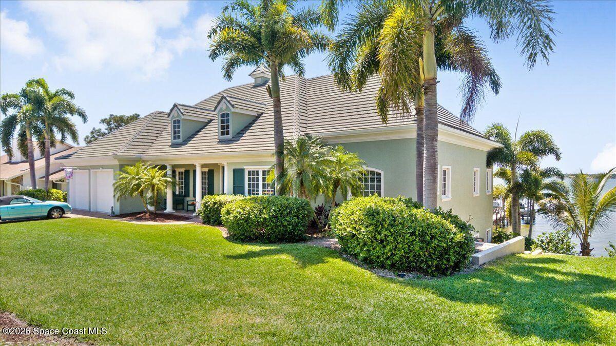 2555 South Tropical Trail Merritt Island, FL 32952 - Photo 7 of 91 a front view of a house with a garden