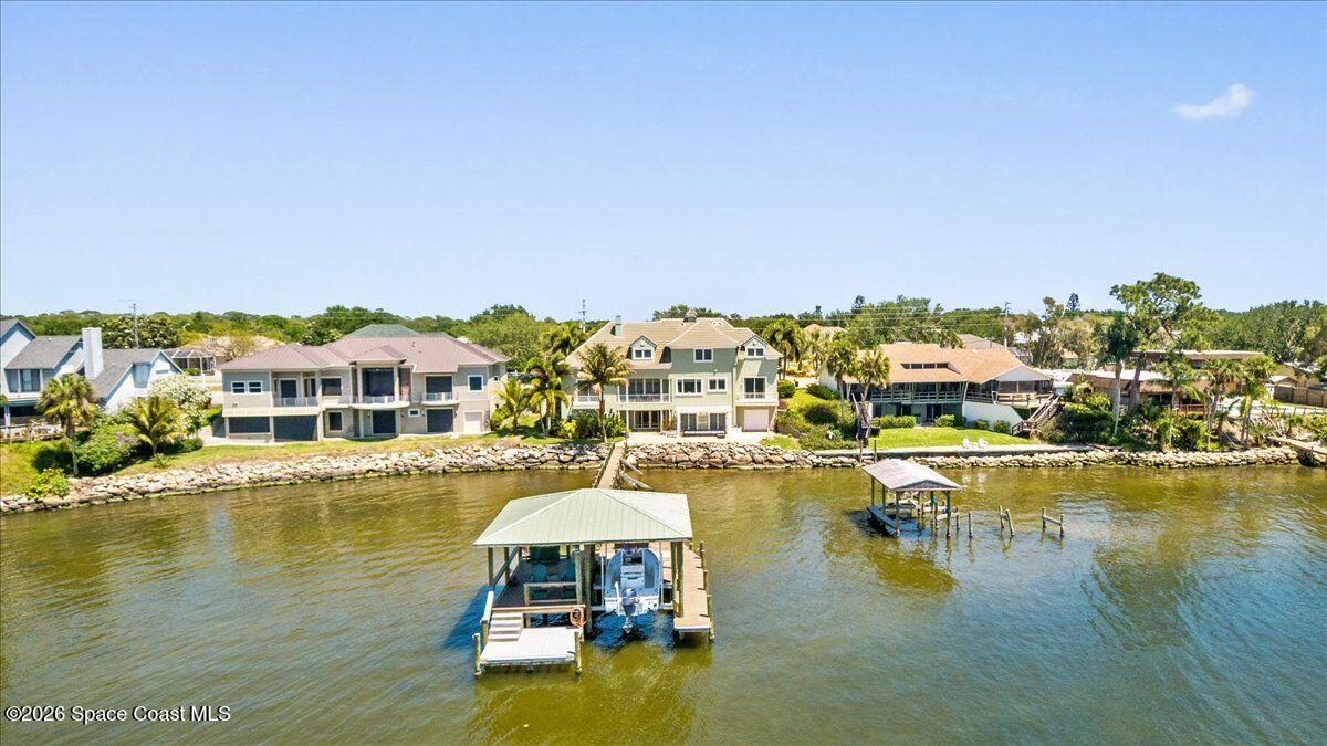 2555 South Tropical Trail Merritt Island, FL 32952 - Photo 72 of 91 a view of a swimming pool with a table and chairs