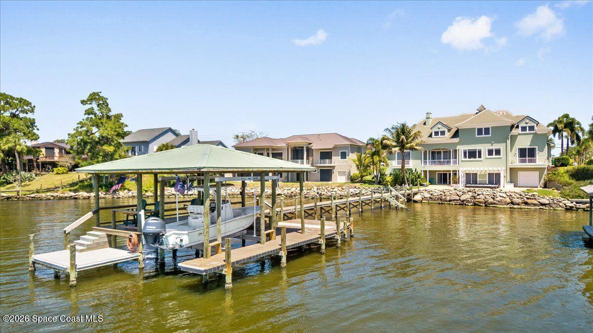 2555 South Tropical Trail Merritt Island, FL 32952 - Photo 73 of 91 a view of a lake with a house swimming pool and outdoor space