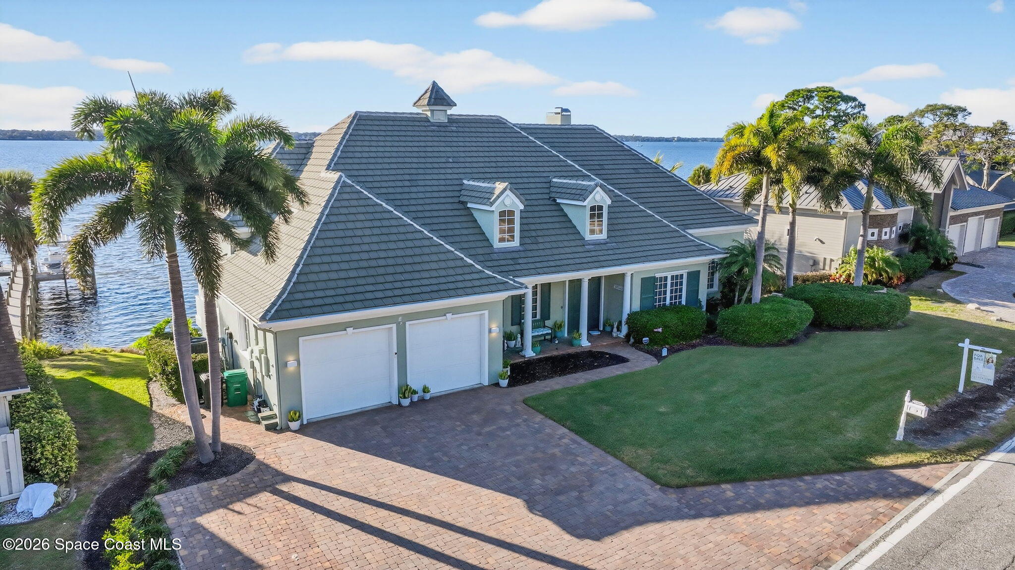 2555 South Tropical Trail Merritt Island, FL 32952 - Photo 88 of 91 a front view of a house with a garden and yard