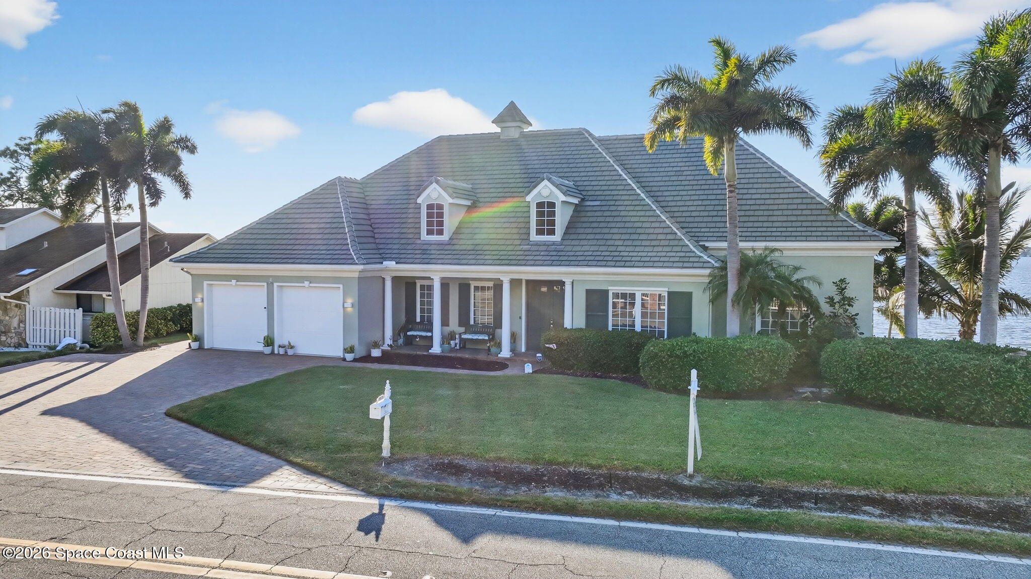 2555 South Tropical Trail Merritt Island, FL 32952 - Photo 90 of 91 a front view of a house with a yard and garage