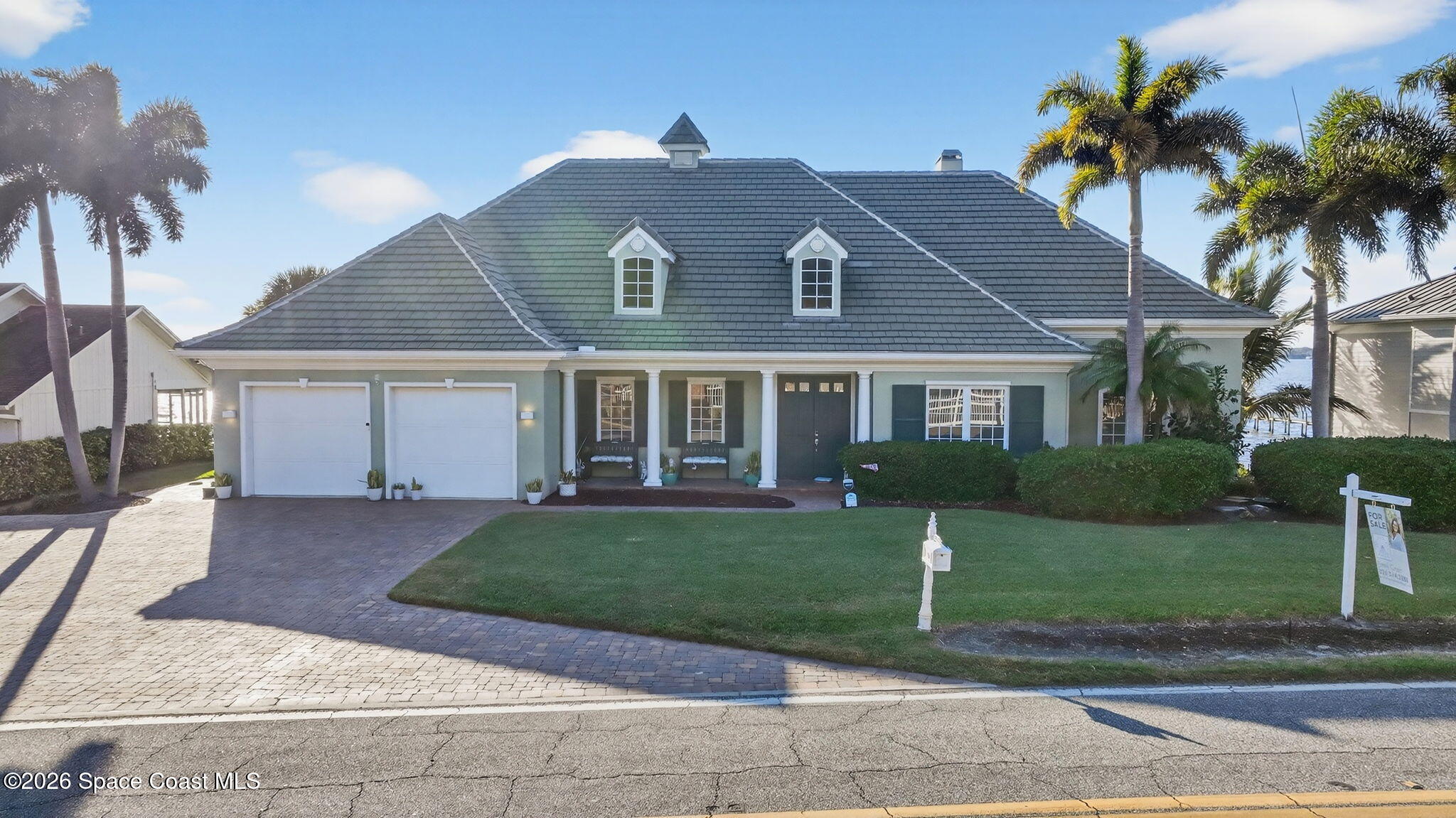 2555 South Tropical Trail Merritt Island, FL 32952 - Photo 91 of 91 a front view of a house with a yard and potted plants