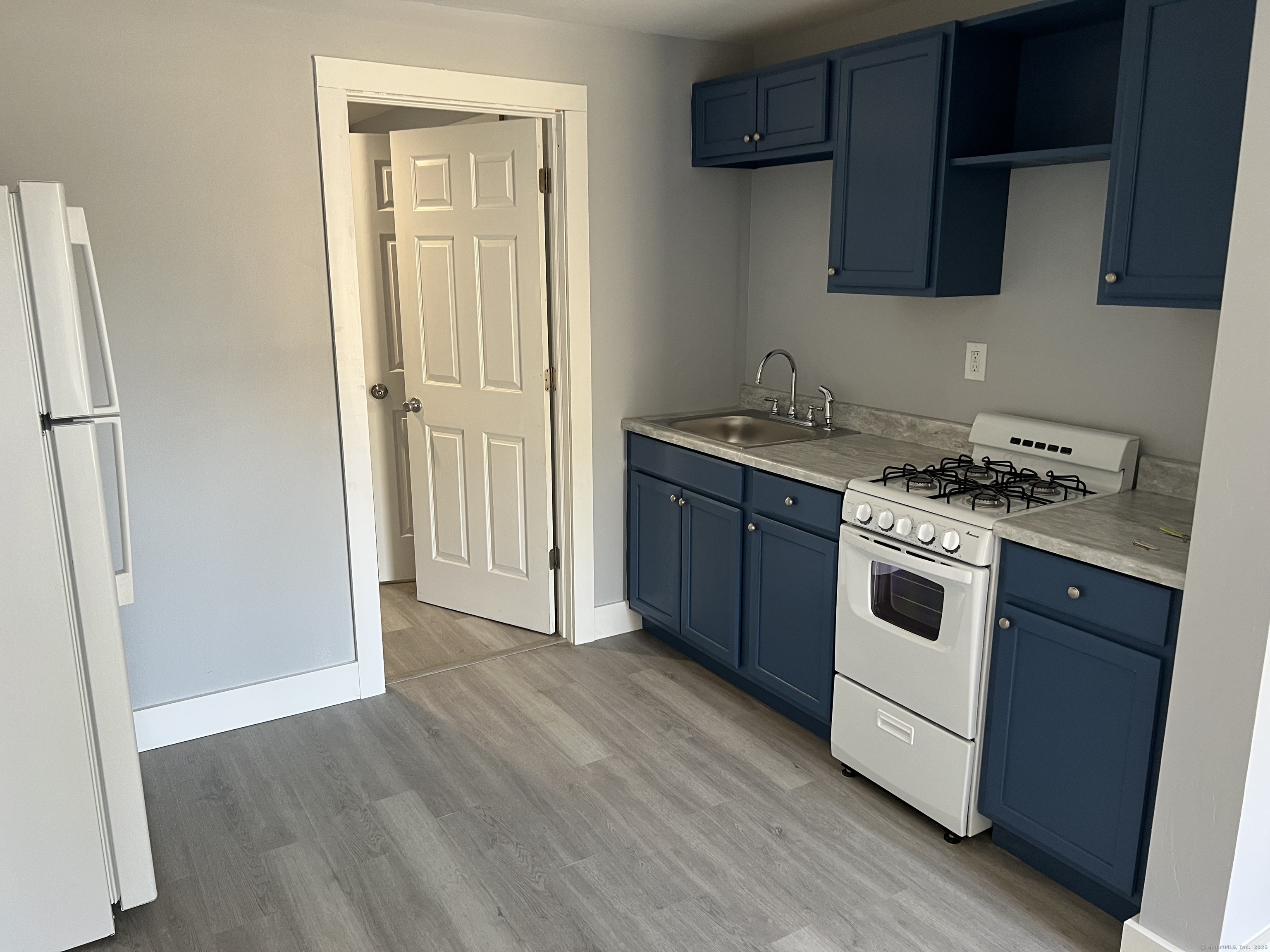a kitchen with a stove and a refrigerator