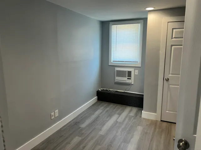 a room with a bed and a window