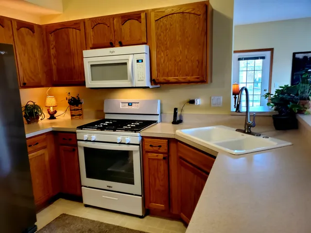 a kitchen with a table chairs and a refrigerator