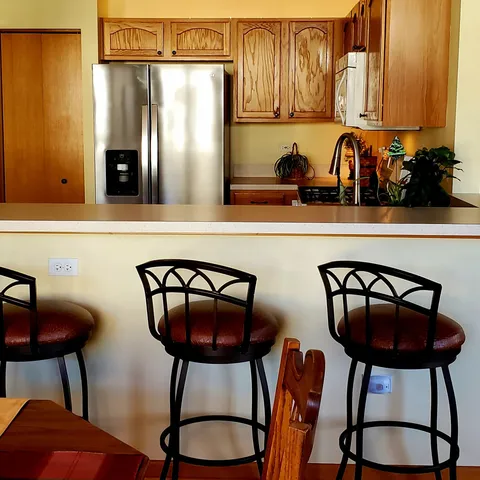 a kitchen with stainless steel appliances granite countertop a refrigerator and a stove