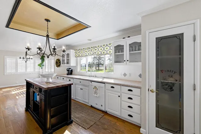 a kitchen with stainless steel appliances granite countertop a sink a stove and a refrigerator