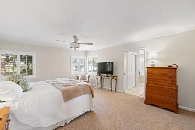 a spacious bedroom with a bed and a television