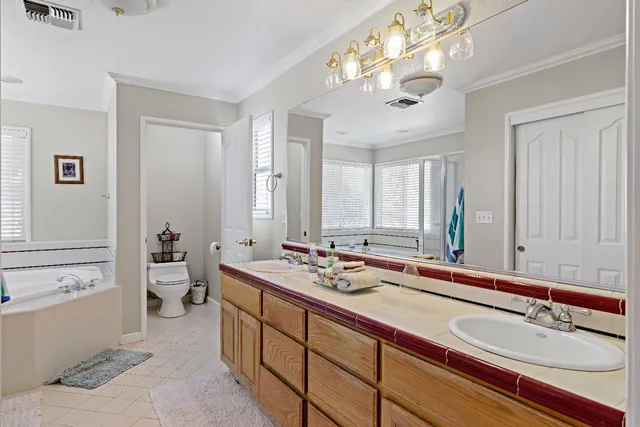 a en suite bathroom with a double vanity sink and a mirror