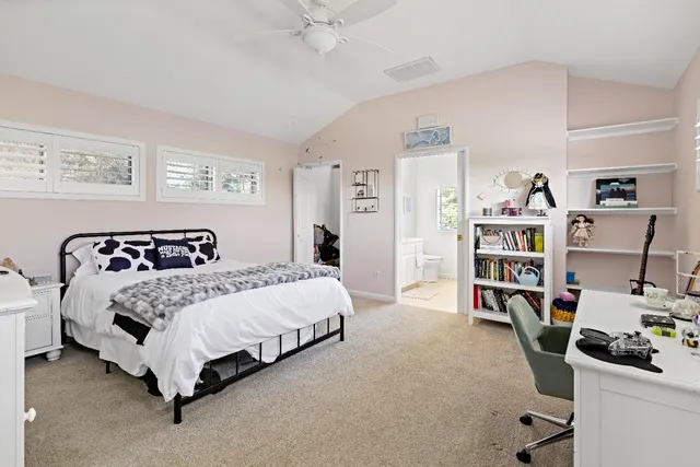 a bedroom with a bed and a book shelf