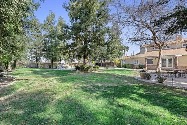 a view of a house with backyard sitting area and garden