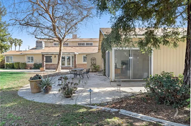 a view of a house with backyard porch and sitting area