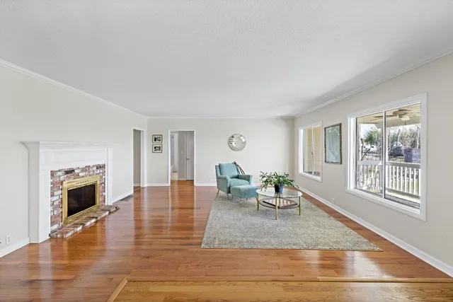a living room with furniture wooden floor and a fireplace