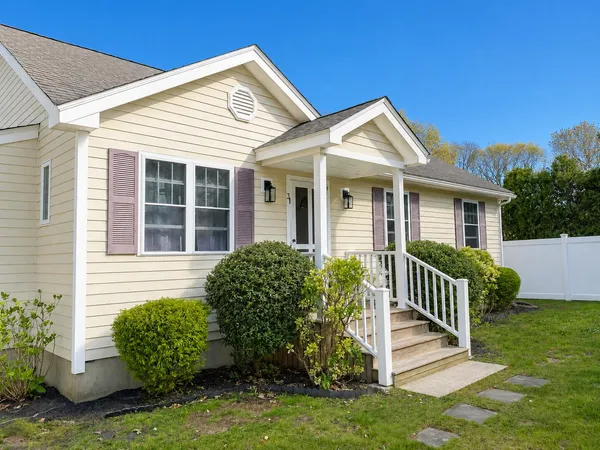 a front view of a house with a yard