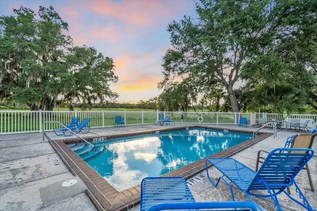 a view of a swimming pool with a lounge chair
