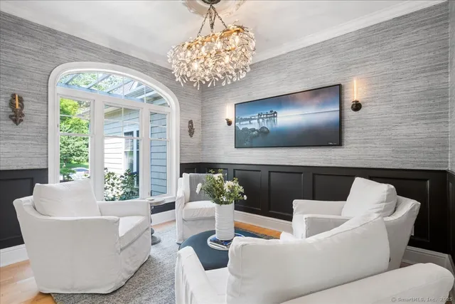 a living room with furniture and a chandelier
